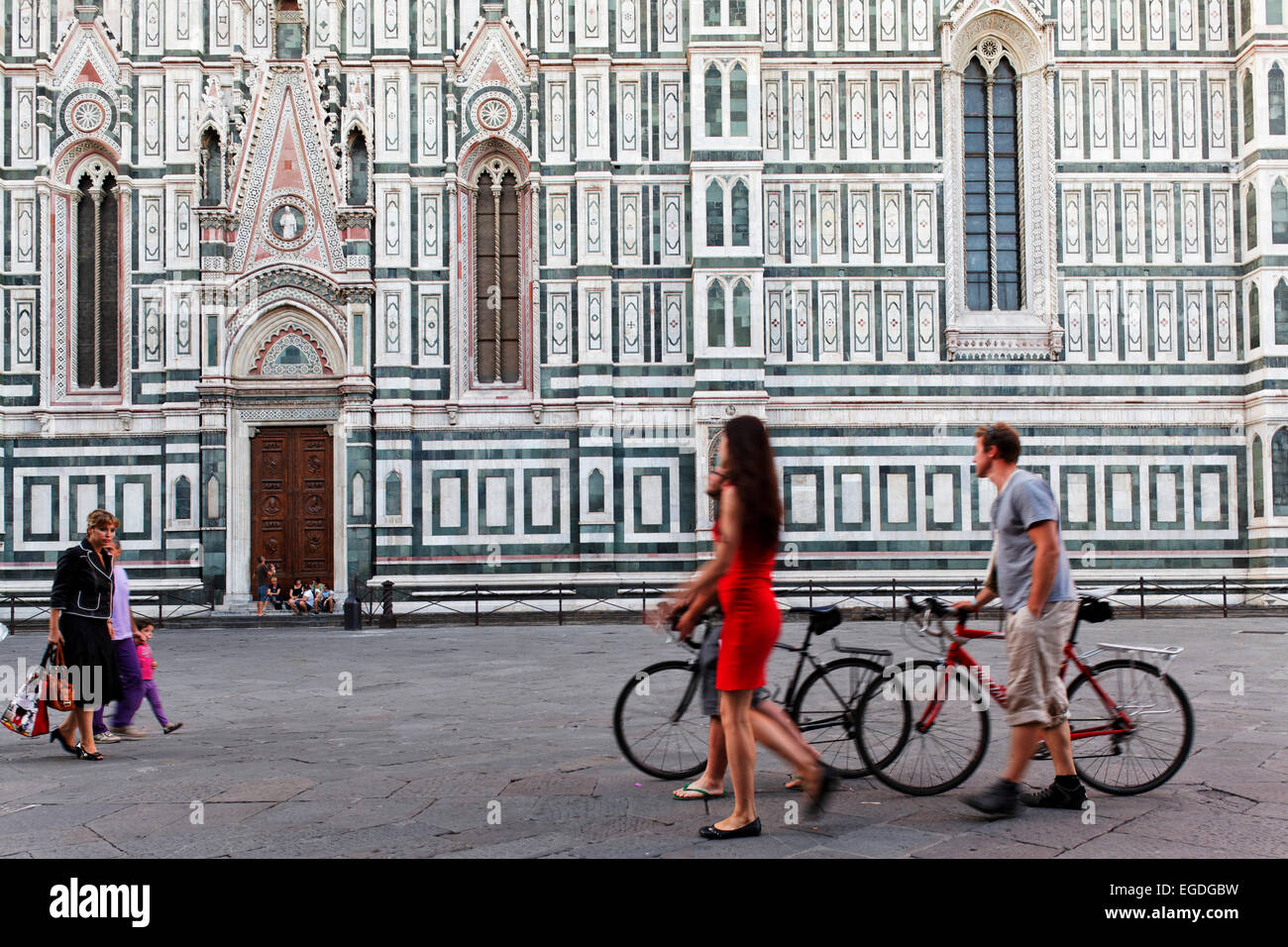 Les gens qui passent le côté façade de la cathédrale, Kathedrale Santa Maria del Fiore, Florence, Toscane, Italie Banque D'Images