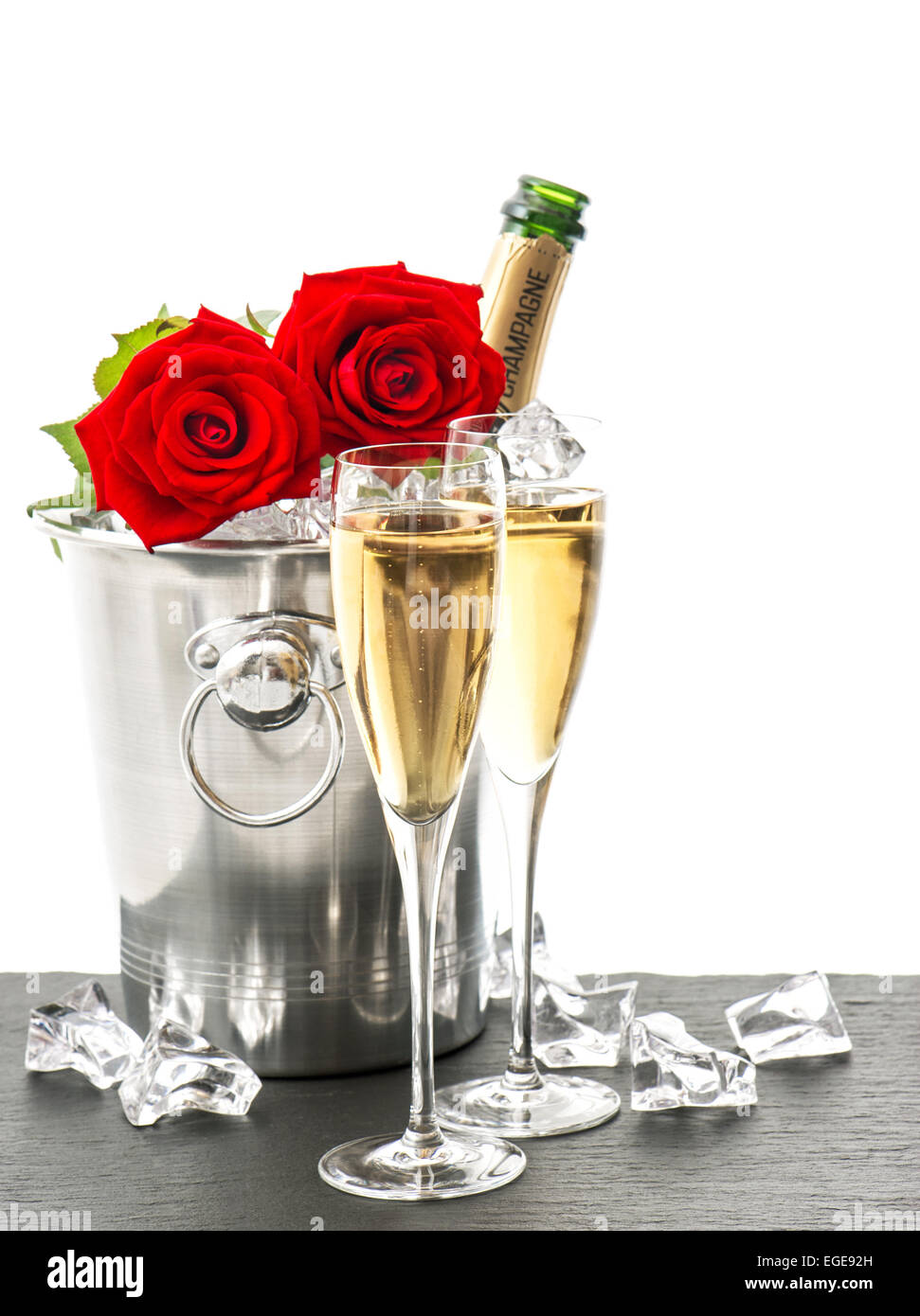 Champagne, deux verres et roses rouges. Arrangement de fête avec du vin mousseux et des fleurs Banque D'Images