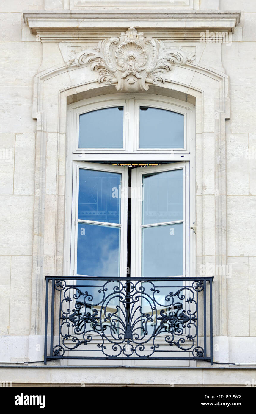 Une grande fenêtre s'ouvre sur un balcon en fer forgé à Paris. Banque D'Images