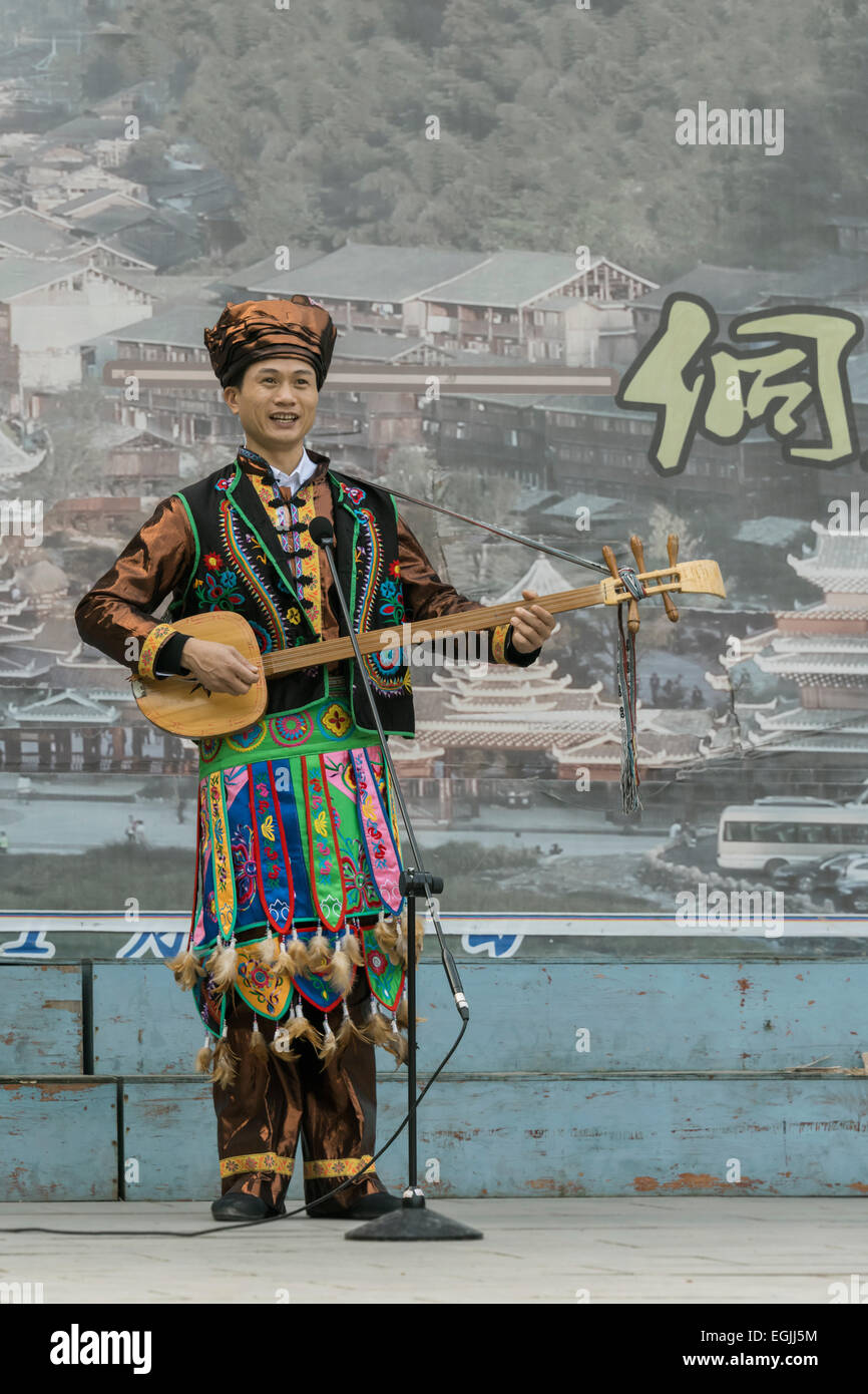 L'homme en costume ethnique Dong jouant un pipa, Zhaoxing village Dong, province de Guizhou, Chine Banque D'Images