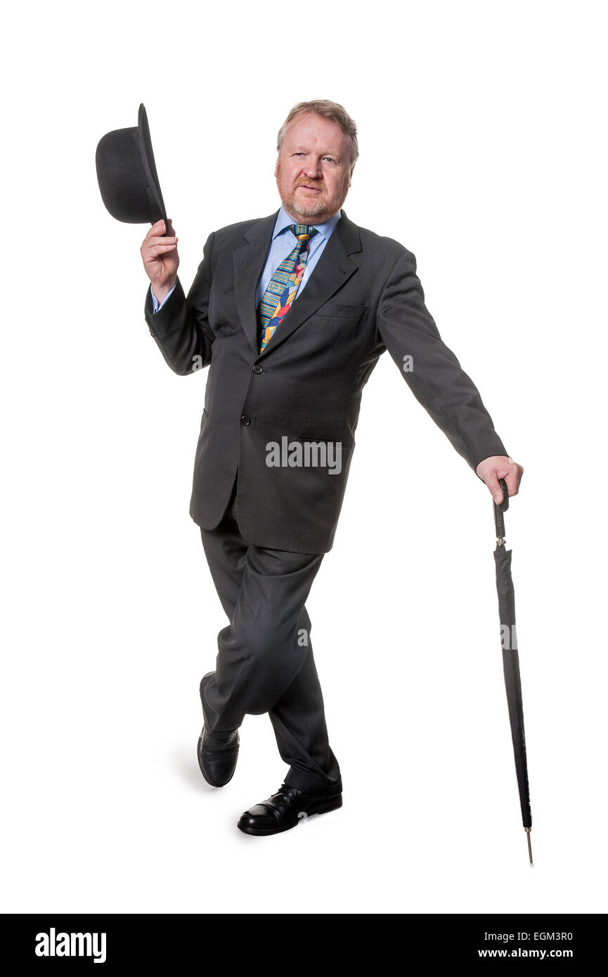 Happy middle aged man in suit holding bowler hat, avec parasol, isolated on white Banque D'Images