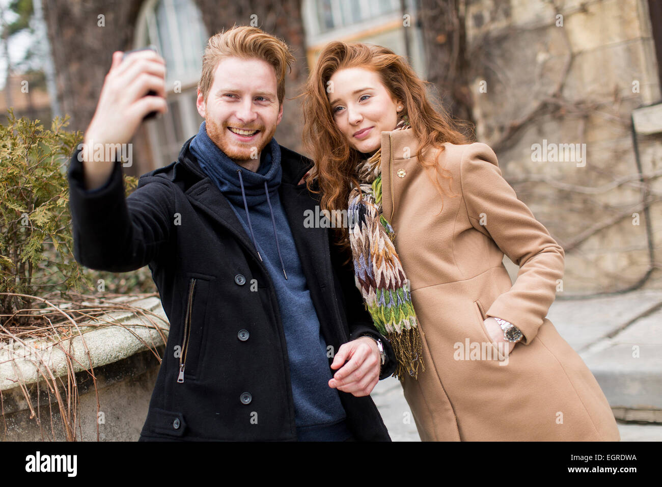 Jeune couple taking photo with mobile phone Banque D'Images