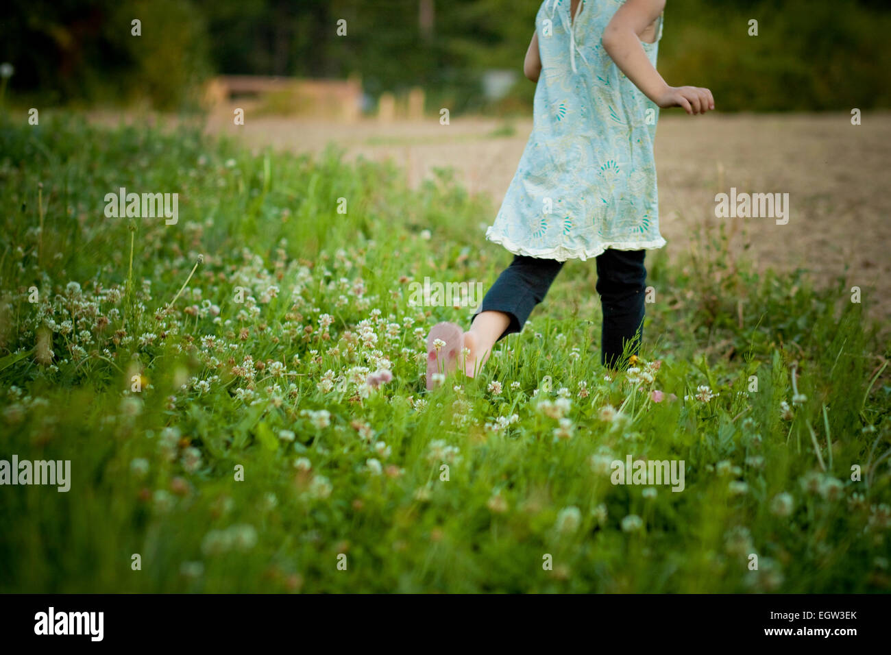 Girl walking through a déposé des fleurs. Banque D'Images