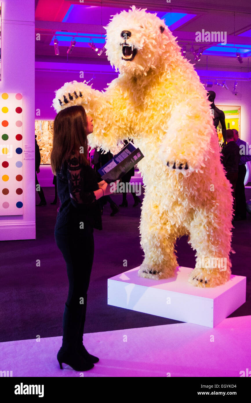 Londres, Royaume-Uni. 4 mars, 2015. Sotheby's à Londres accueille les "l'une des plus extraordinaires collections de notre temps', un anonyme de la grande assemblée des pièces d'art, dont des crânes d'ours, sculptures, peintures et installations. Photo : une femme examine Paola Pivi's 'La vie est belle", une sculpture d'ours polaire géant couvertes de plumes. Crédit : Paul Davey/Alamy Live News Banque D'Images