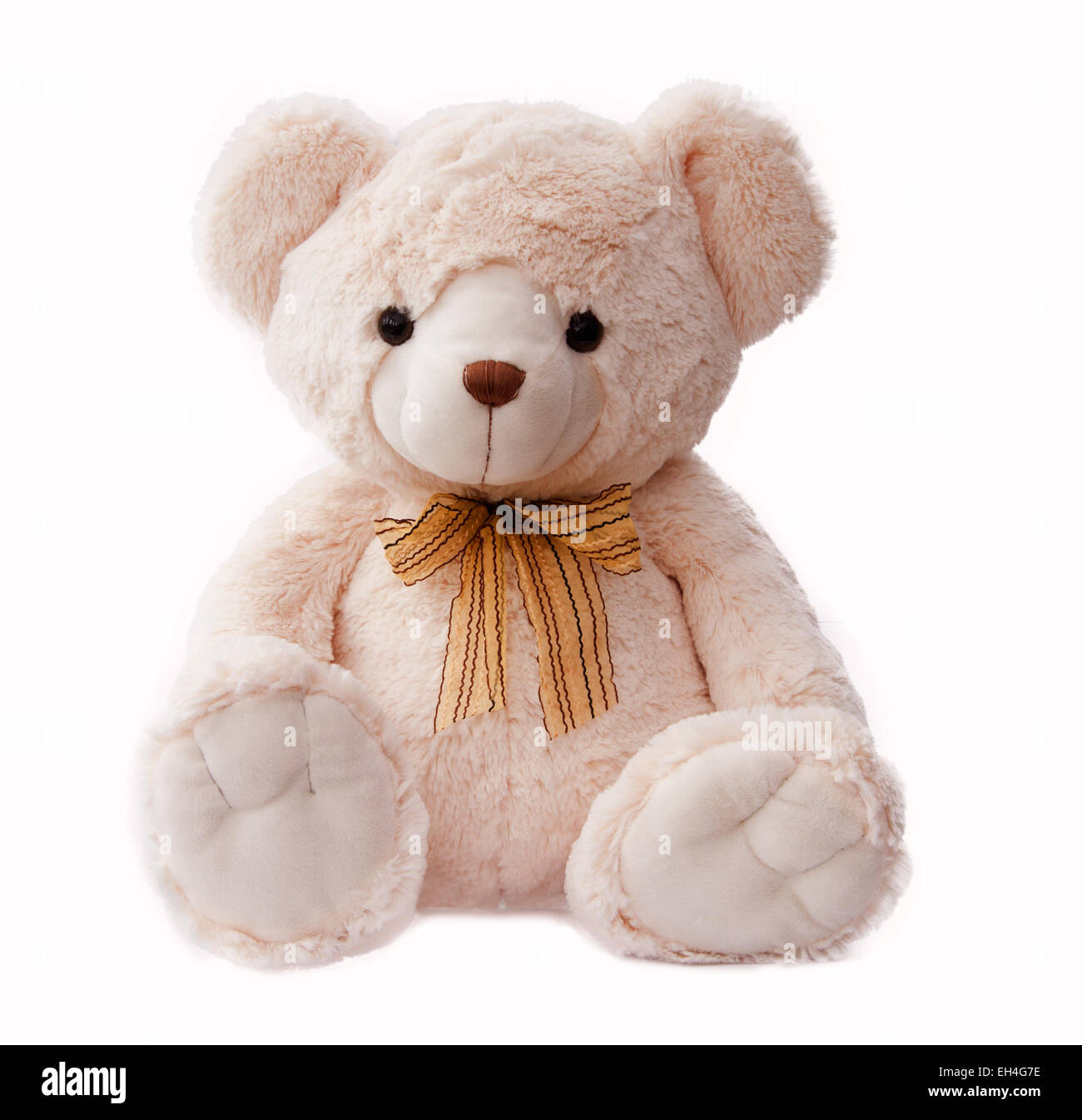 Ours de couleur crème avec un arc jaune et marron, isolé sur un fond blanc. Banque D'Images