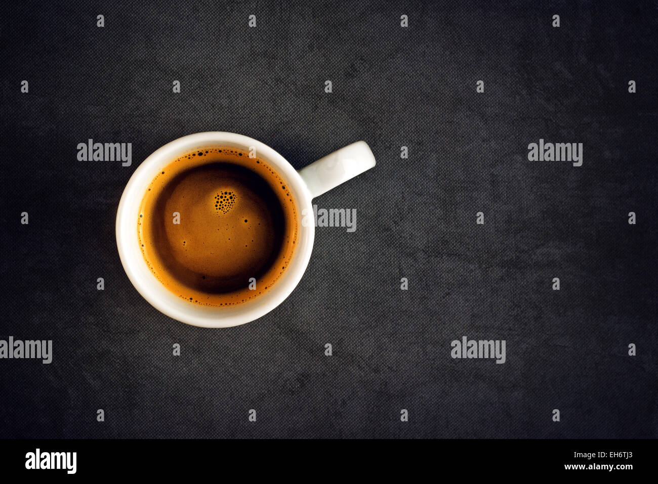 Vue de dessus d'une tasse de café noir, blanc céramique Mug gris Grunge sur tapis de table. Banque D'Images