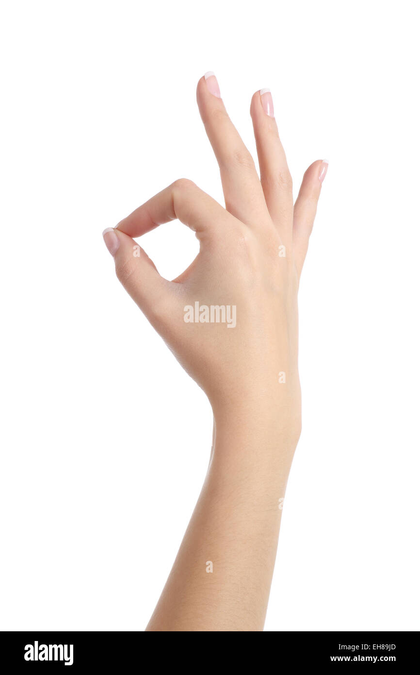 Main femme avec une parfaite manucure gesturing ok isolé sur fond blanc Banque D'Images