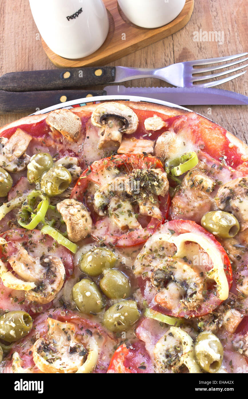 De délicieuses pizzas italiennes servi sur table en bois Banque D'Images