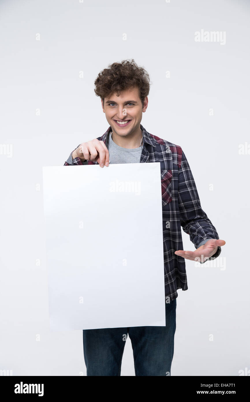 Smiling man with curly hair holding blank billboard Banque D'Images
