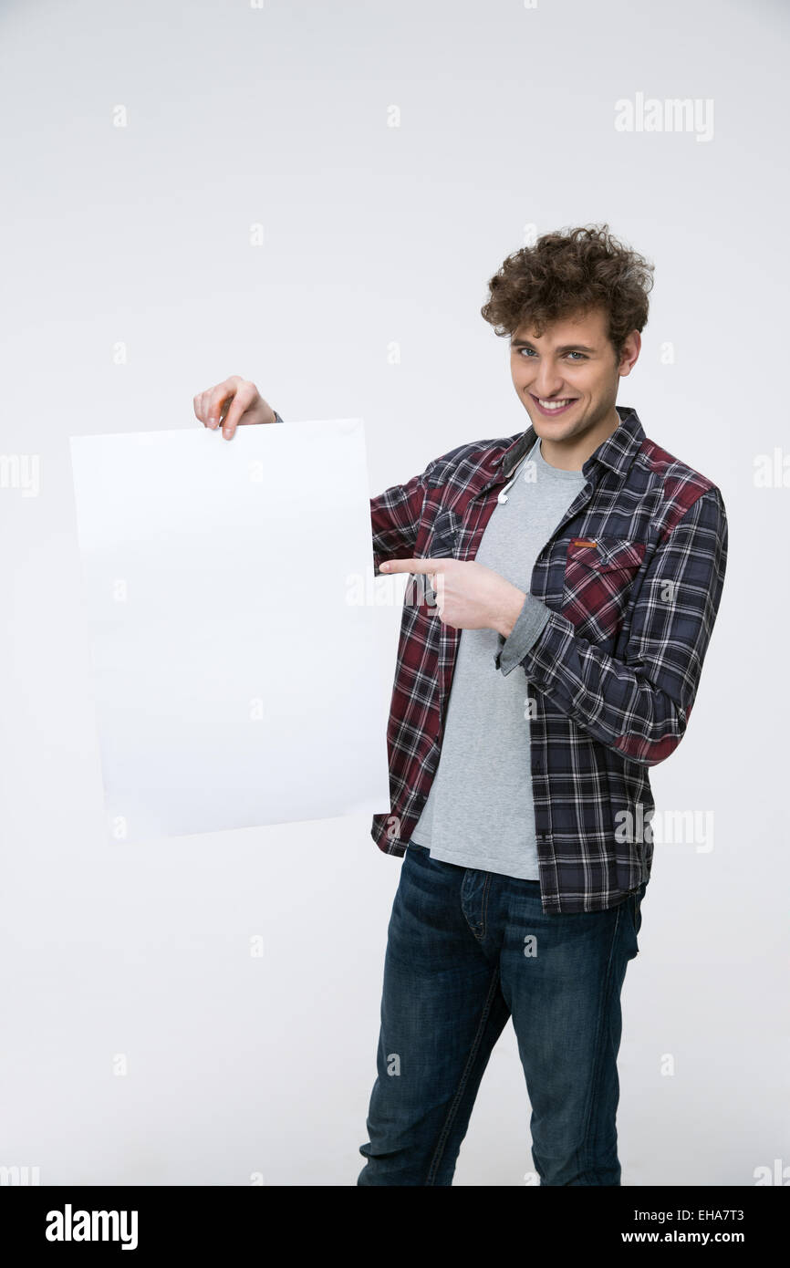 Cheerful man with curly hair holding blank billboard Banque D'Images
