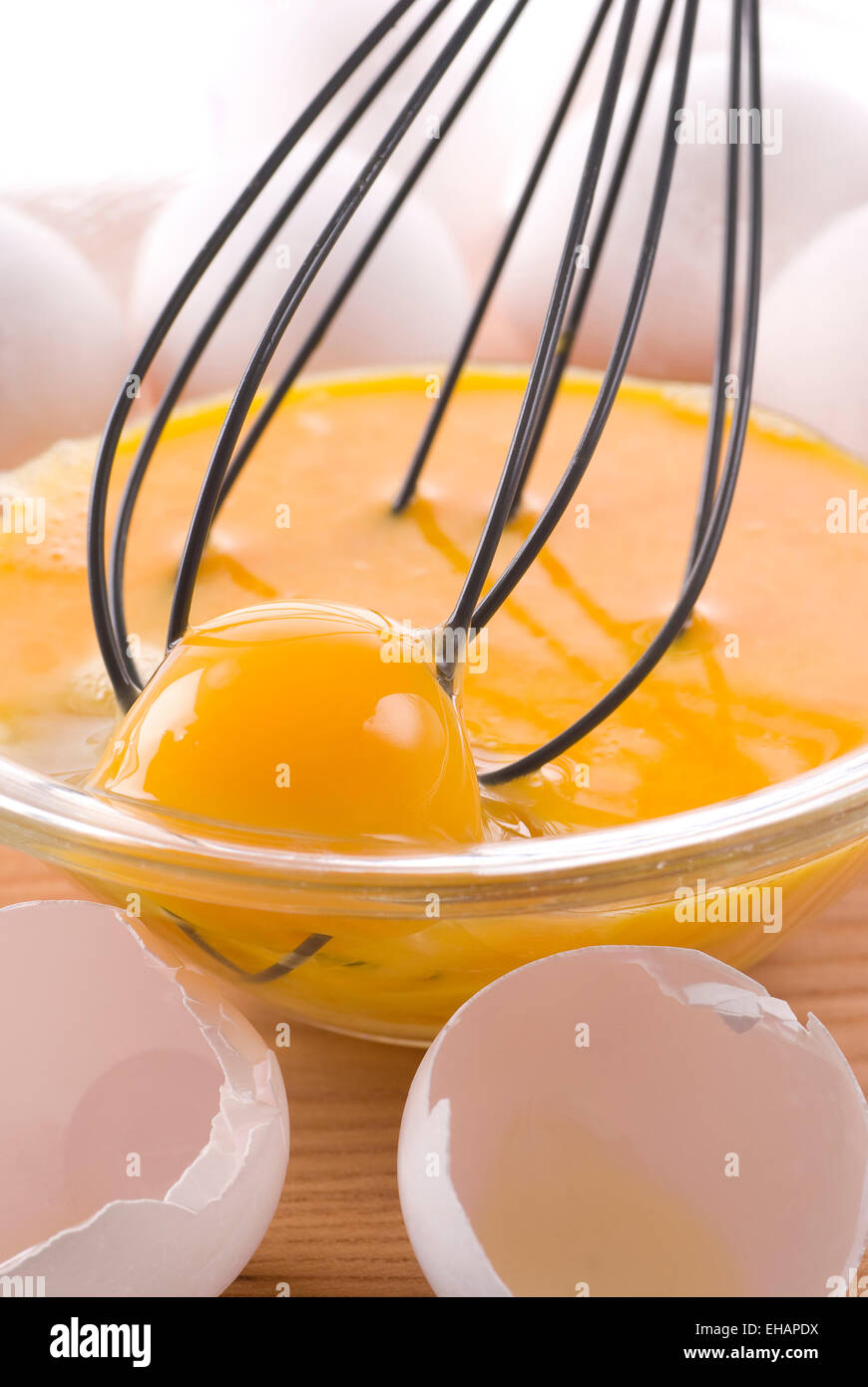 Oeufs frais fouetter dans un bol en verre. Banque D'Images