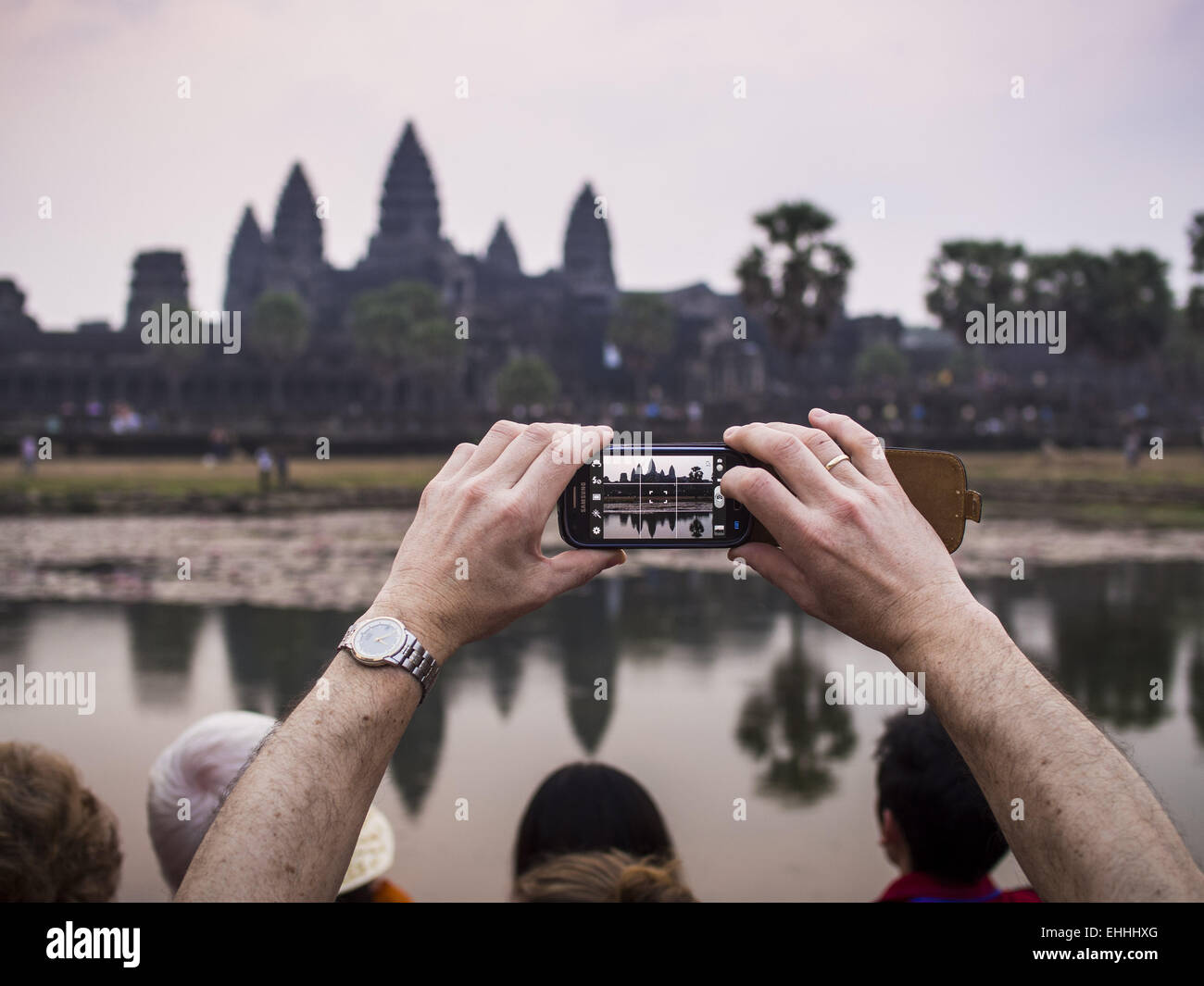 Phnom Penh, Cambodge, Phnom Penh. 14Th Mar, 2015. Un touriste photos Angkor Wat avec son smart phone au lever du soleil. La région connue sous le nom de ''Angkor Wat'' est une collection de ruines archéologiques et de temples. La zone a été développé par d'anciens Khmer (cambodgien) Kings dès 1150 CE et a rénové et agrandi autour de 1180CE par Jayavarman VII. Angkor Wat est maintenant considérée comme la septième merveille du monde et est le plus important du Cambodge en attraction touristique. © Jack Kurtz/ZUMA/Alamy Fil Live News Banque D'Images