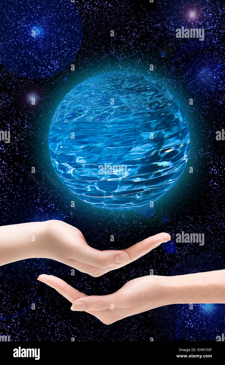 Deux mains tiennent une planète dans l'Univers Banque D'Images