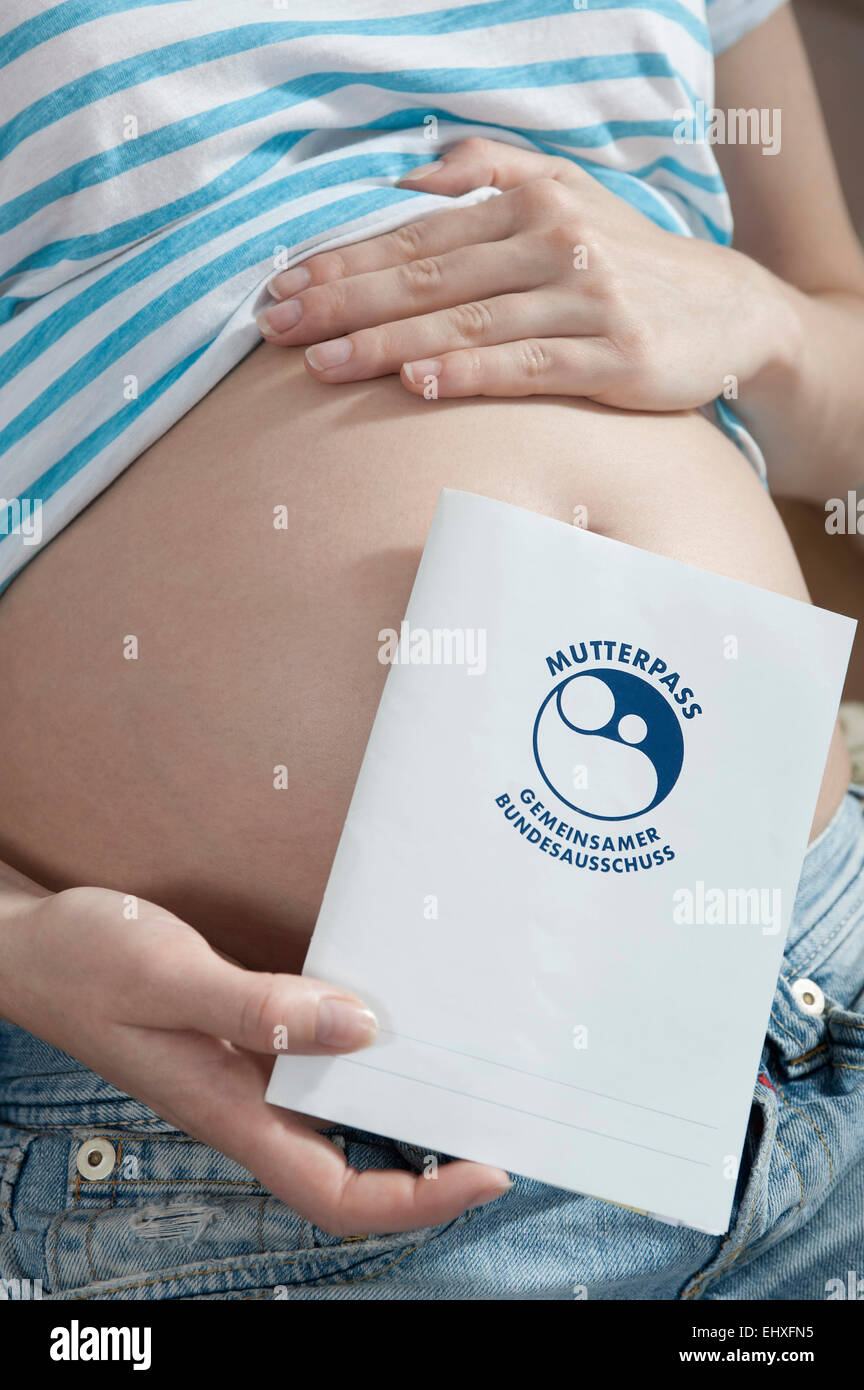 Pregnant woman holding journal livre protocole maternité Banque D'Images