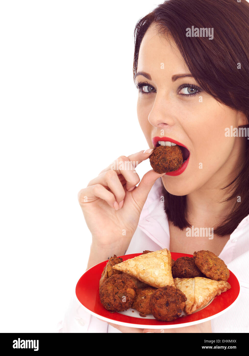 Attractive young woman eating indian Snack food Banque D'Images