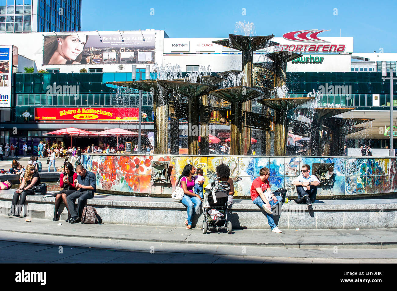 Les gens de vous rafraîchir autour d'une fontaine à l'Alexanderplatz à Berlin, Allemagne sur une journée chaude. Banque D'Images