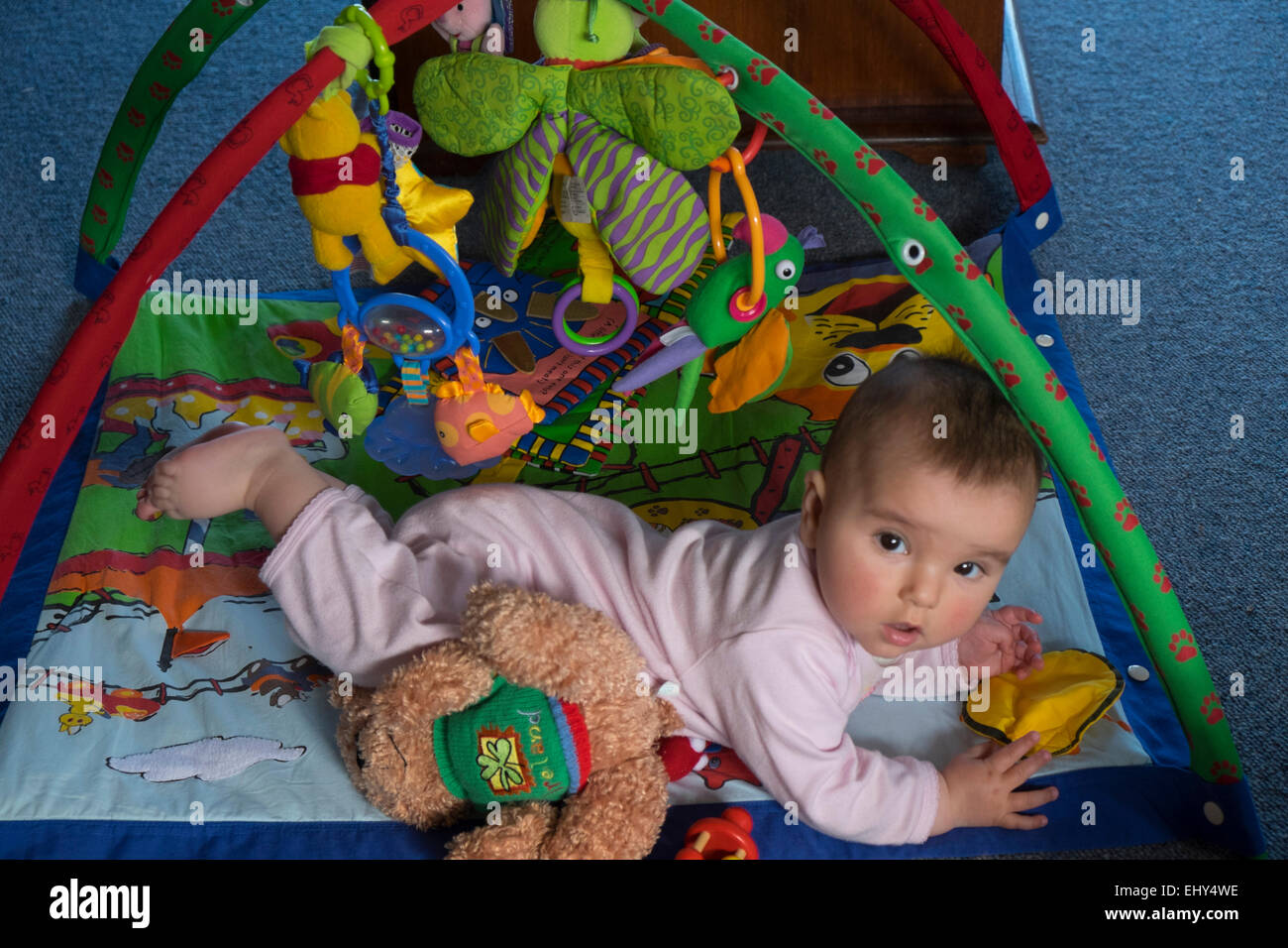 8 mois bébé fille jouant sur marbre avec jouet interactif Banque D'Images