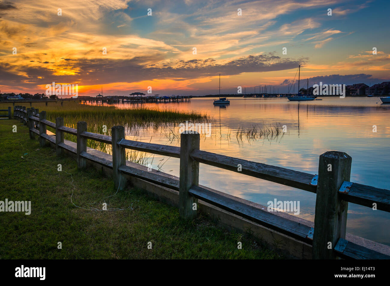 Clôture et coucher de soleil sur la rivière de la folie, à Folly Beach, Caroline du Sud. Banque D'Images