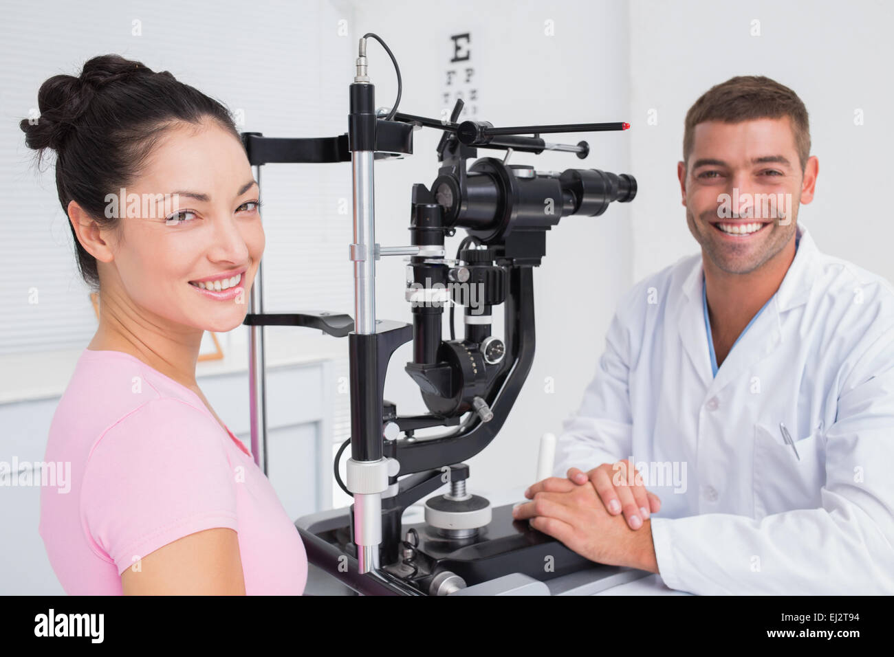 Opticien heureux et patient de sexe féminin avec lampe à fente Banque D'Images