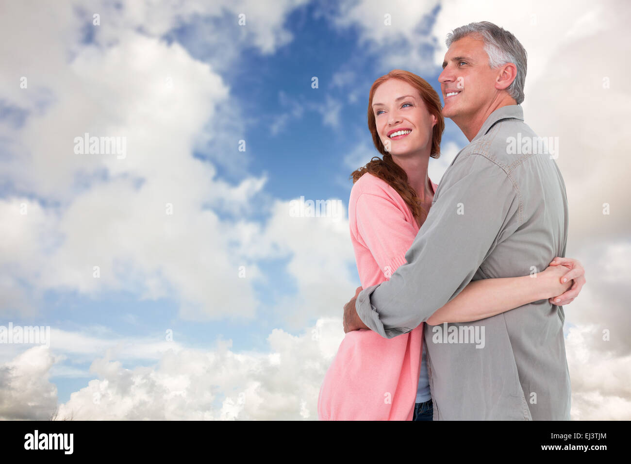 Image composite de casual couple hugging and smiling Banque D'Images