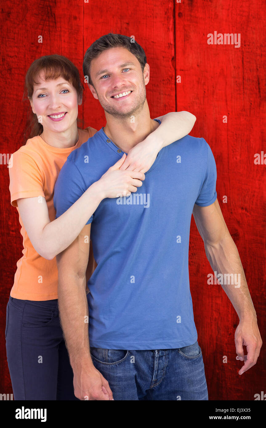 Image composite de l'heureux couple looking at camera Banque D'Images