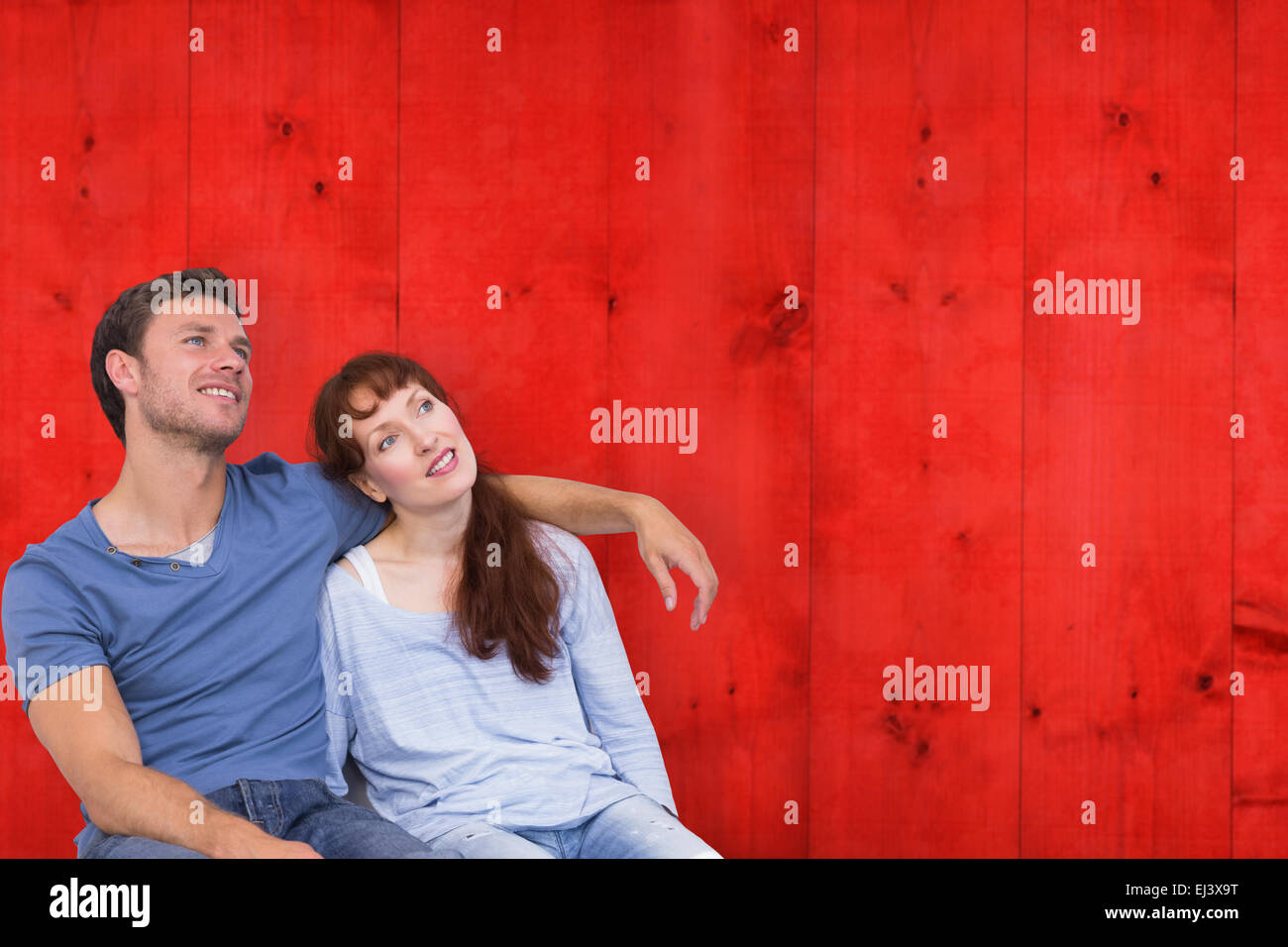 Image composite du couple sitting on floor ensemble Banque D'Images