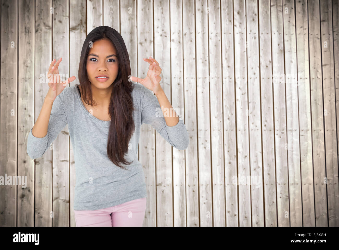 Image composite de angry brunette gesturing Banque D'Images