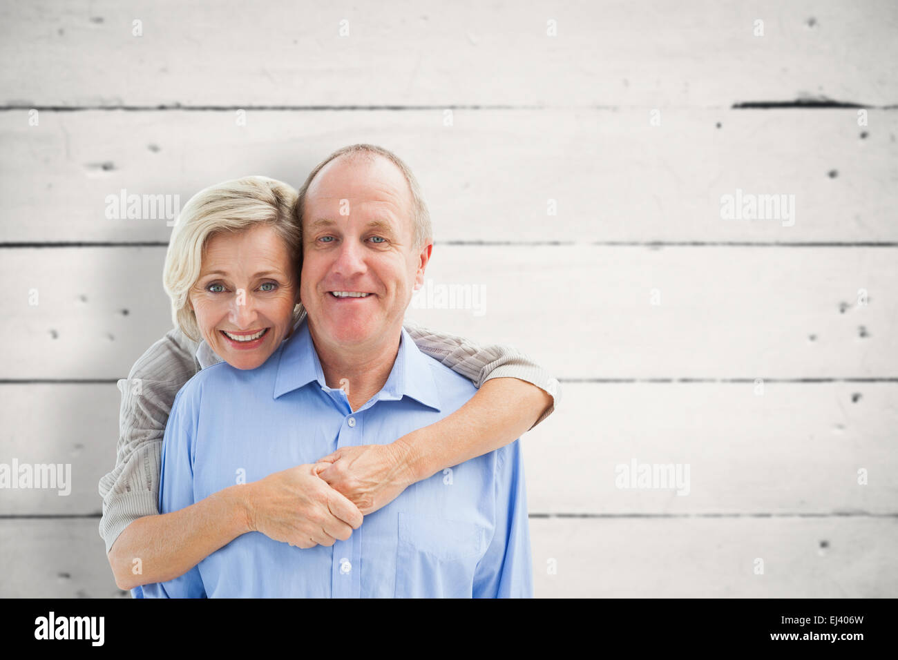 Composite image of happy mature couple smiling at camera Banque D'Images