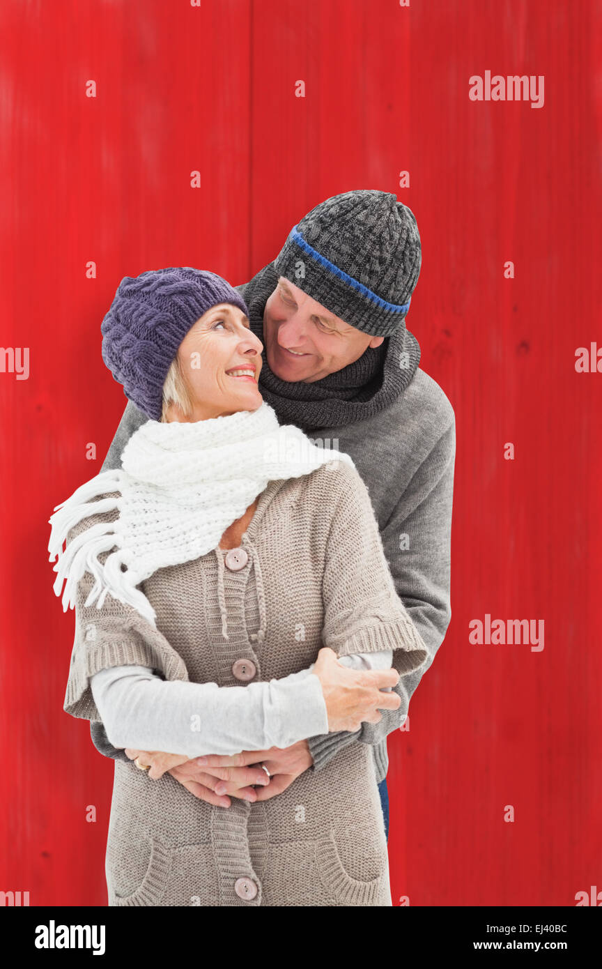 Image composite de mature woman in winter clothes embracing Banque D'Images