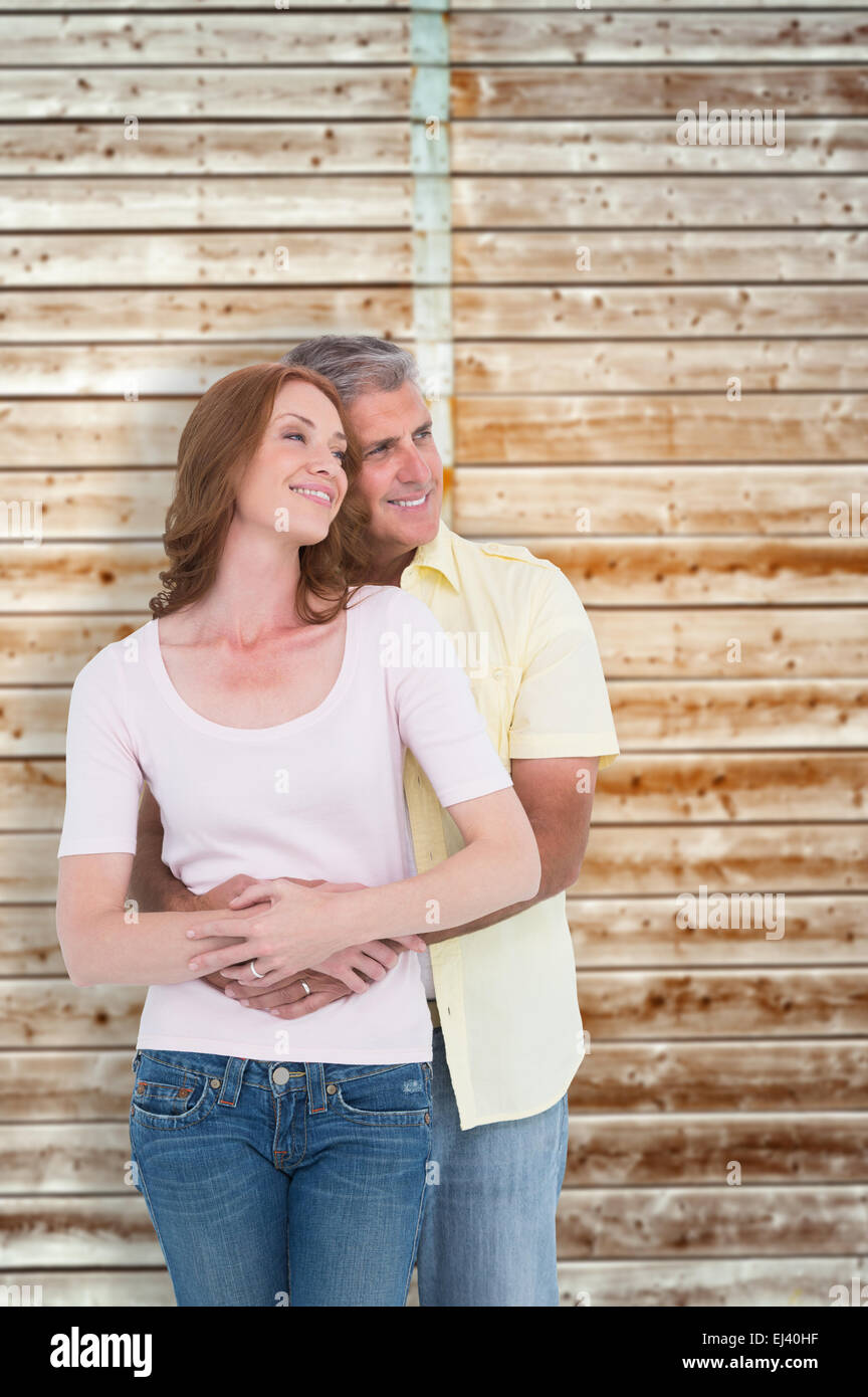 Image composite de casual couple hugging and smiling Banque D'Images