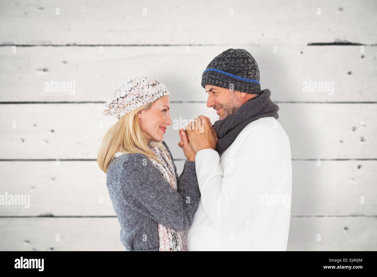 Image composite de couple in winter fashion embracing Banque D'Images