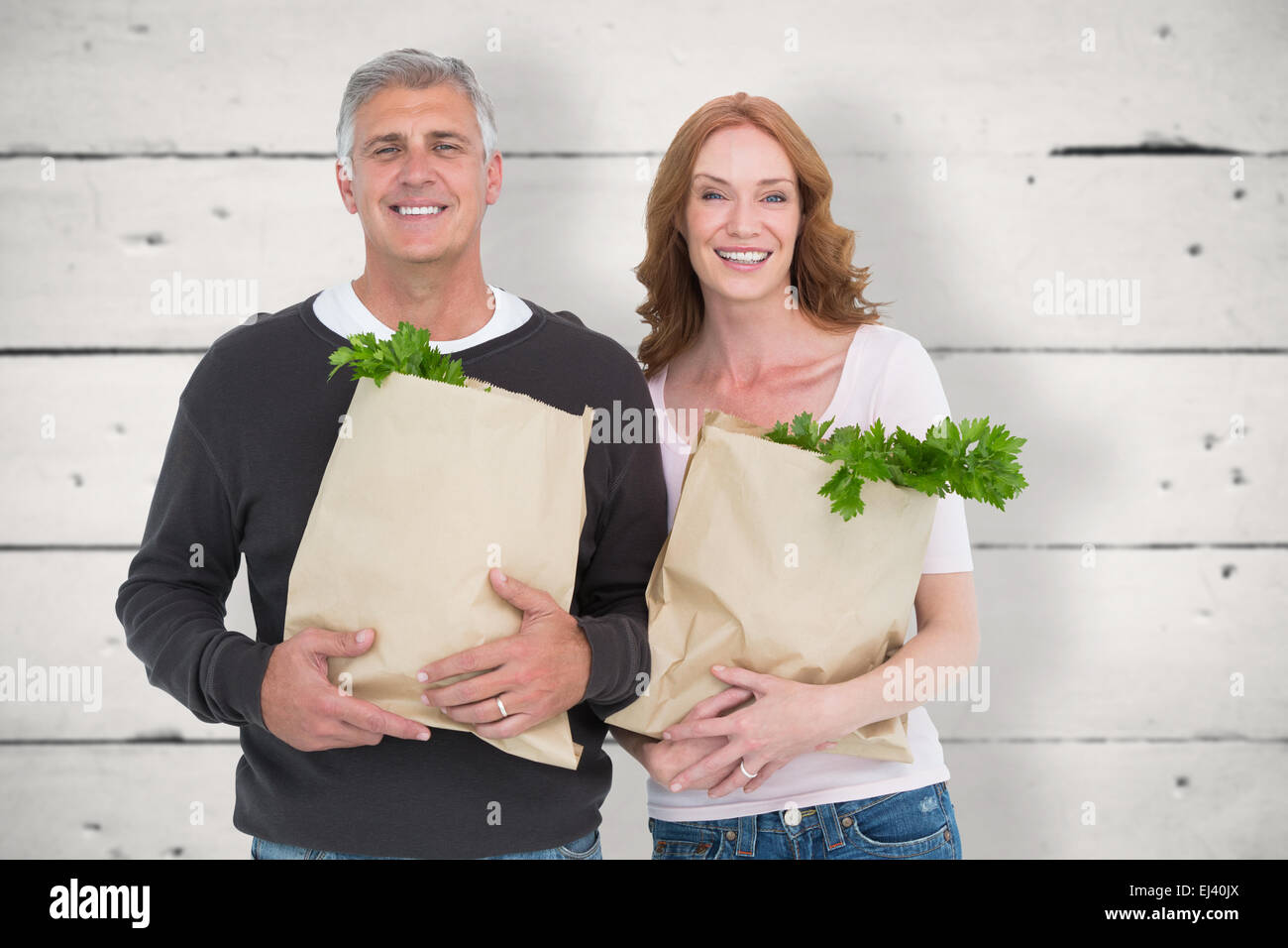Image composite de casual couple holding grocery bags Banque D'Images