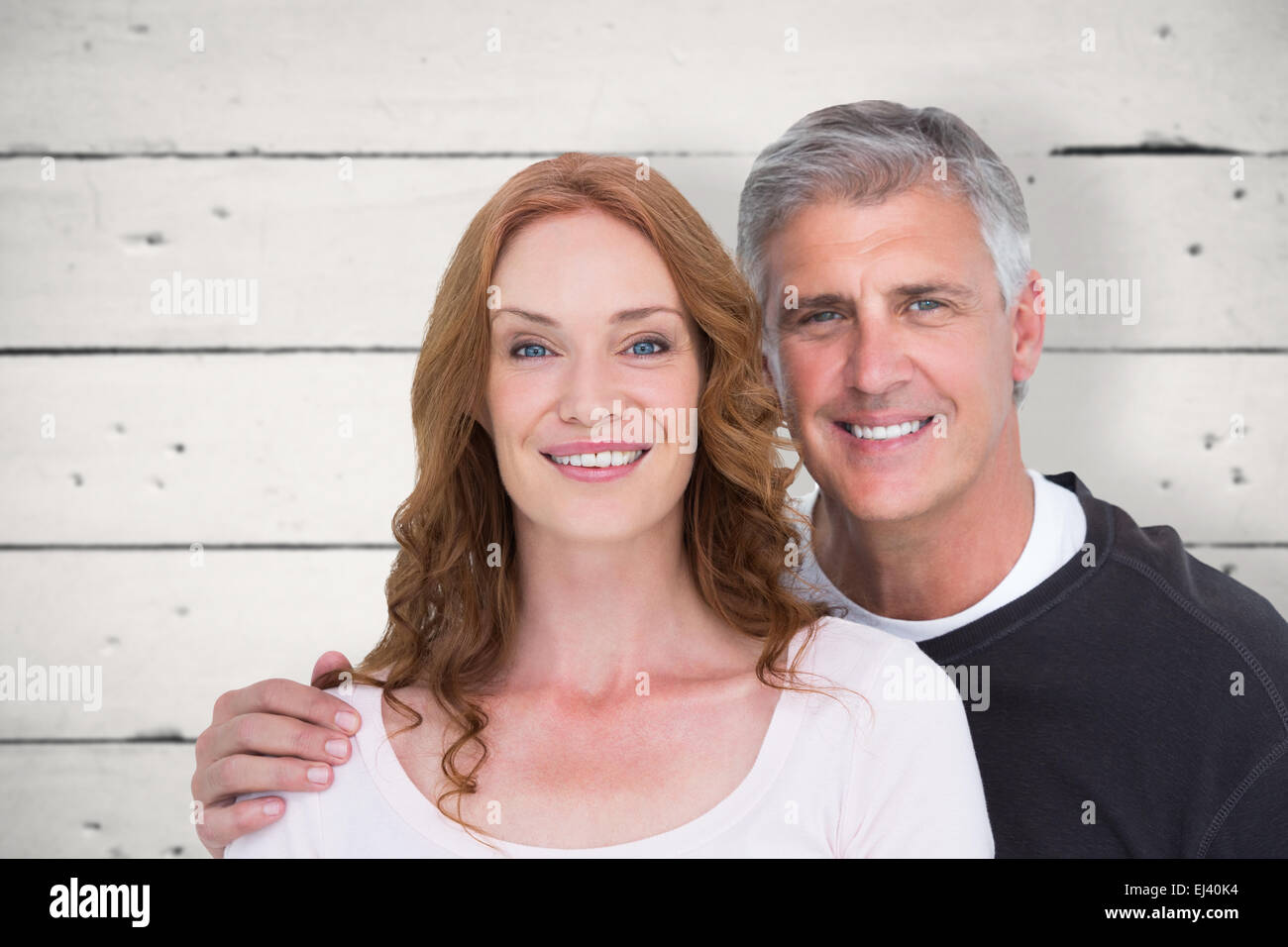Image composite de casual couple smiling at camera Banque D'Images