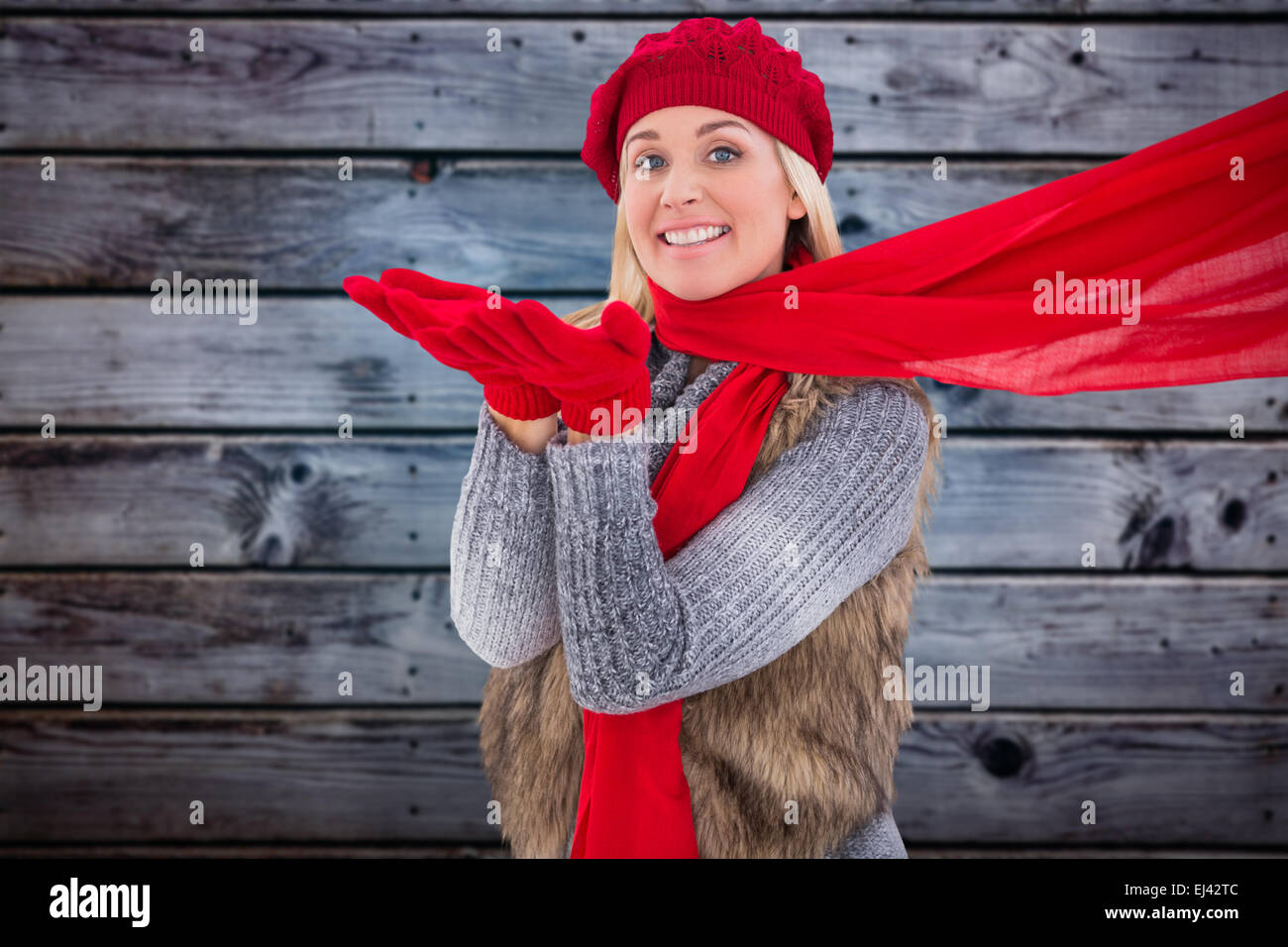 Image composite de blonde en vêtements d'hiver blowing kiss Banque D'Images