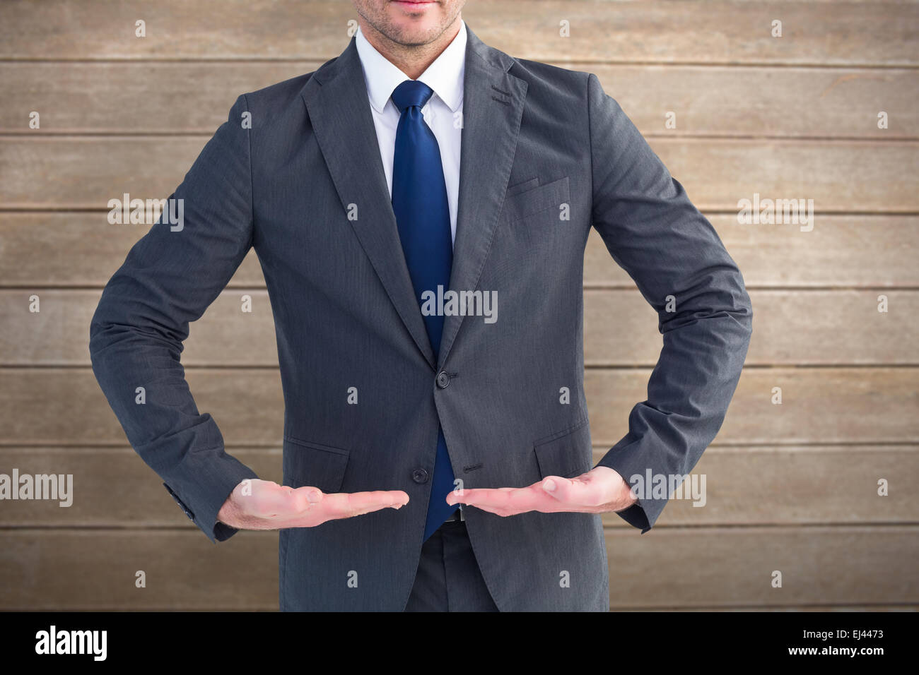 Image composite de businessman standing with hands out Banque D'Images