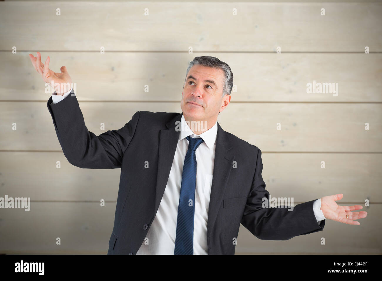 Composite image of businessman holding ses mains Banque D'Images