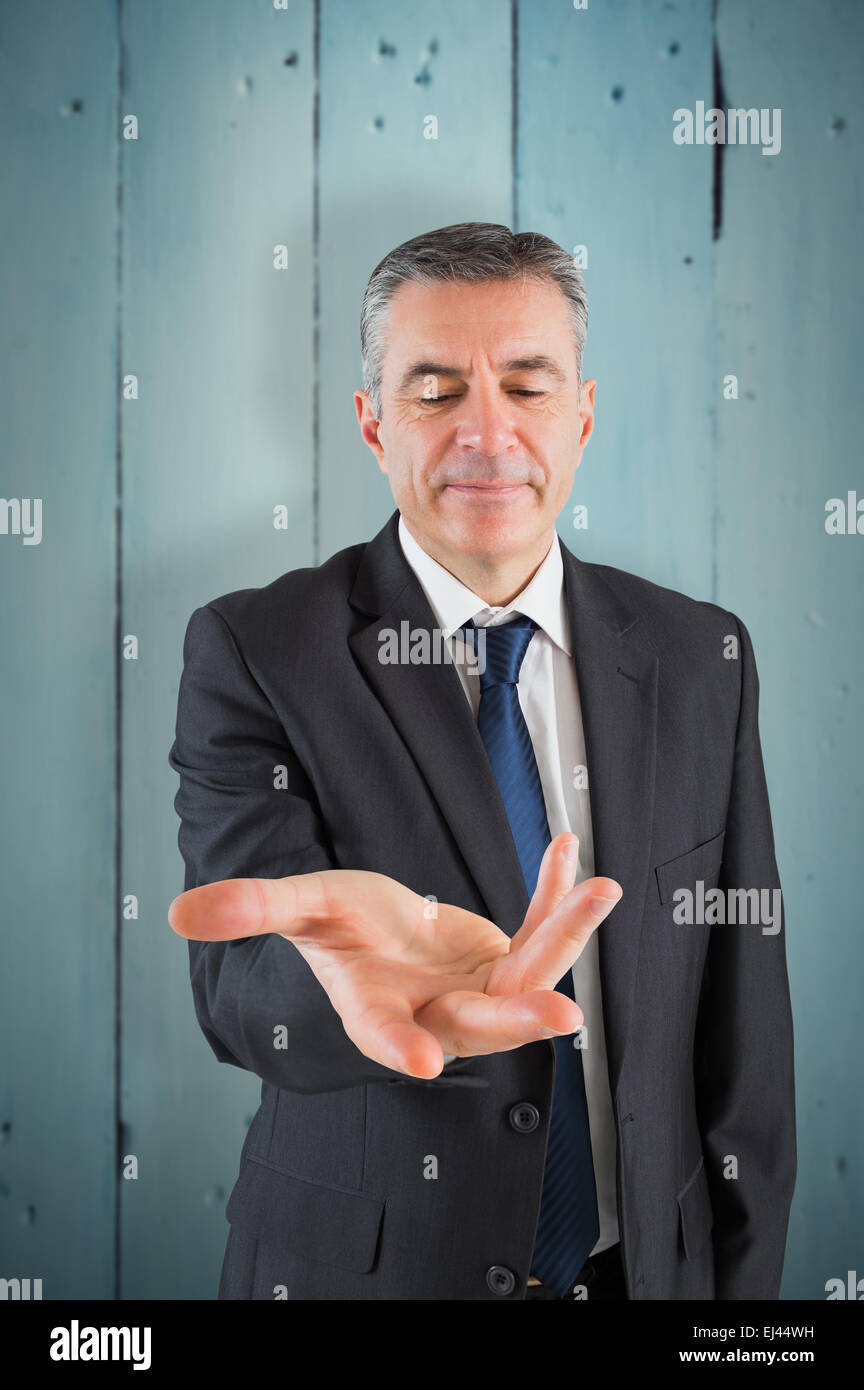 Composite image of businessman holding ses mains Banque D'Images