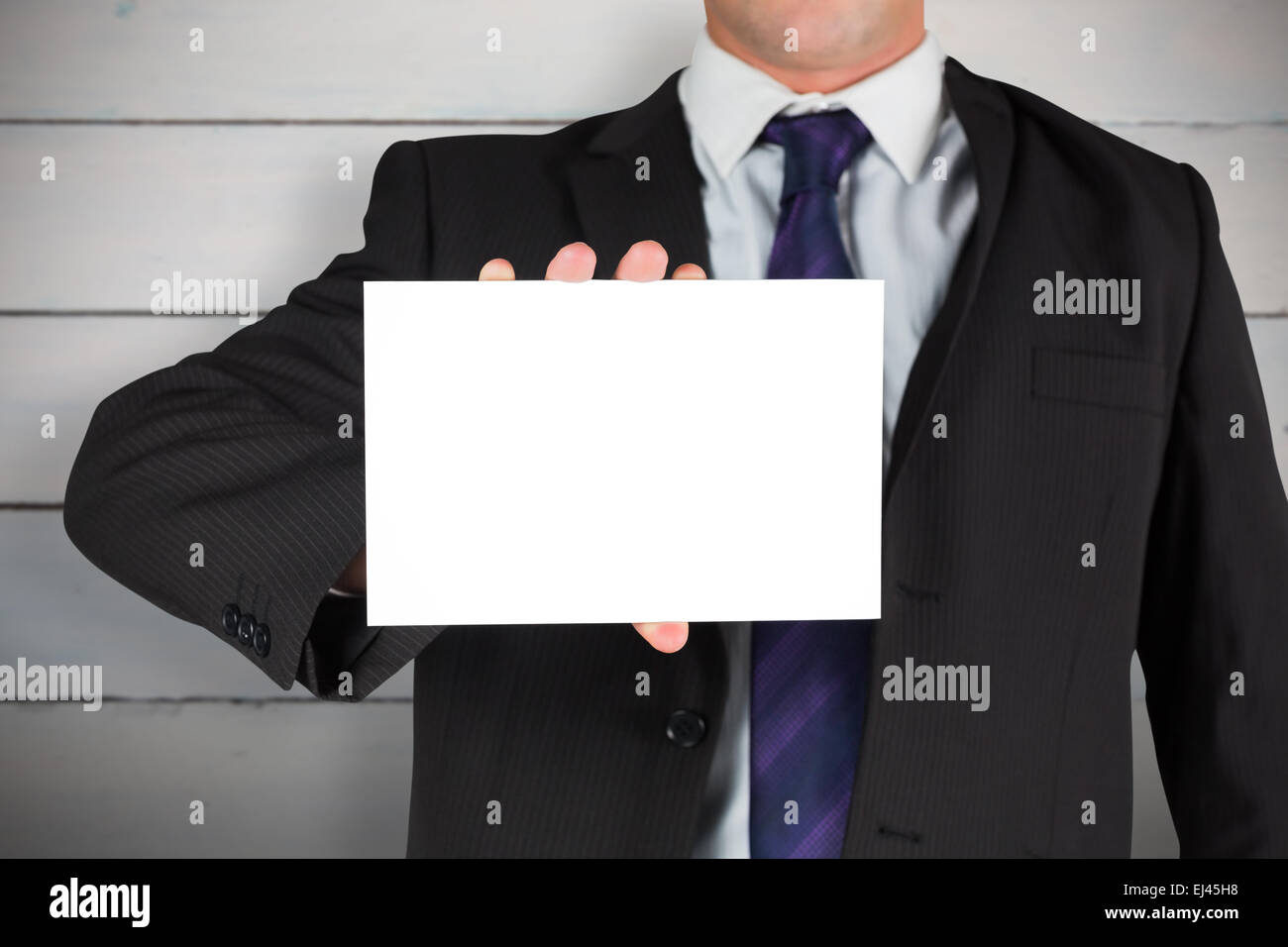 Image composite de businessman showing card Banque D'Images