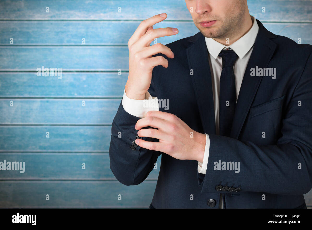 Image composite de handsome businessman adjusting ses menottes Banque D'Images