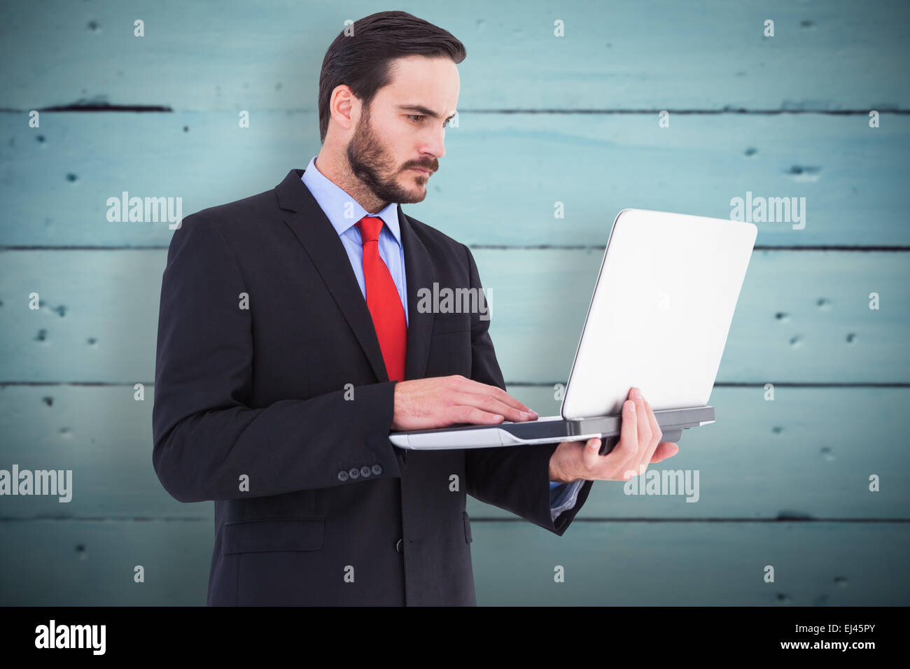 Composite image of businessman en utilisant son ordinateur portable Banque D'Images