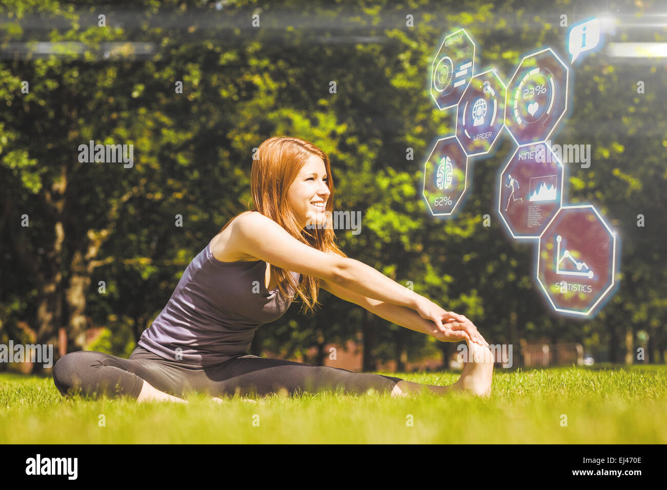 Image composite de jolie rousse smiling stretching in park Banque D'Images