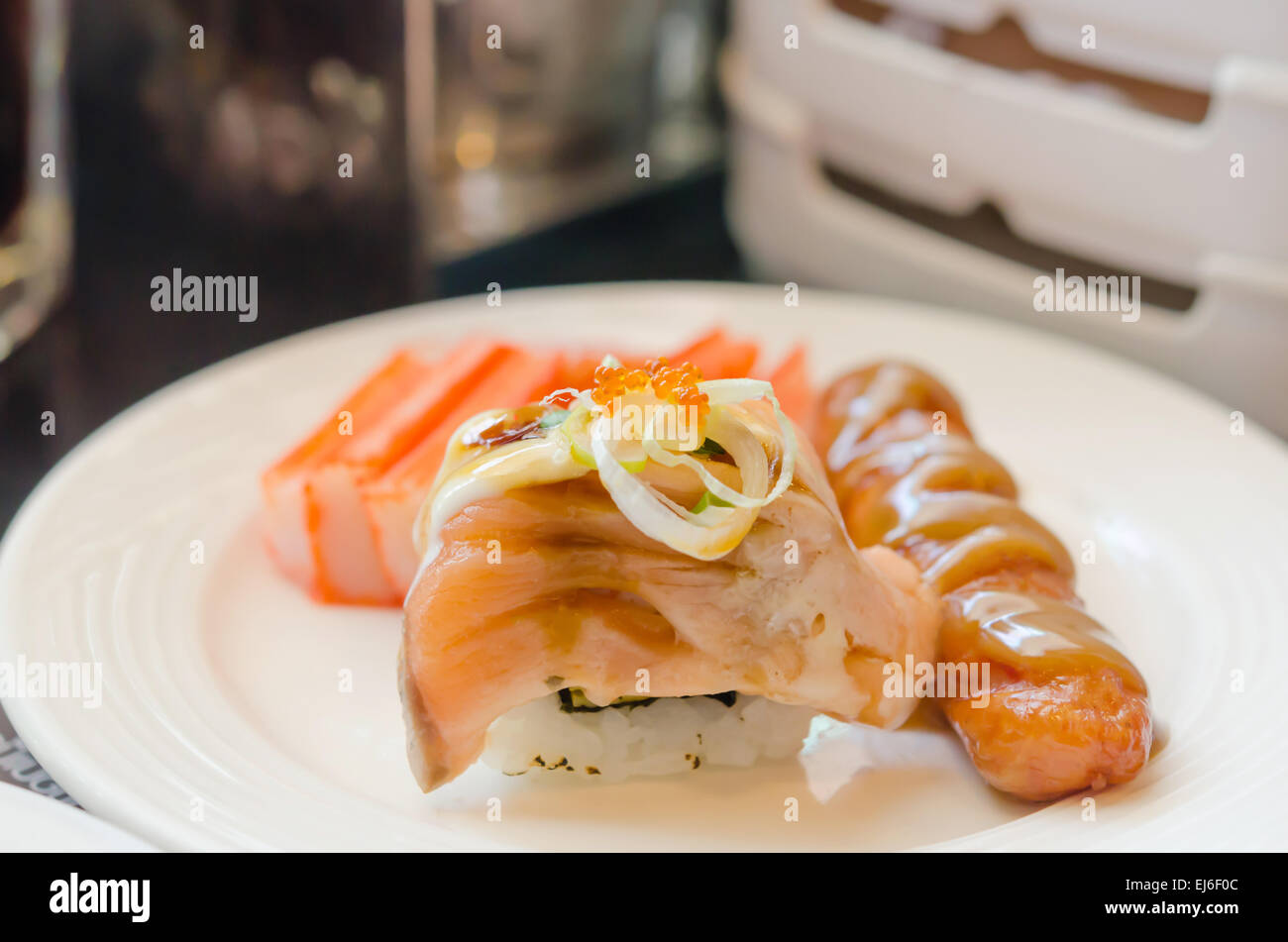 Rouleau de saumon sushi avec de la saucisse et le crabe strick en blanc lave Banque D'Images