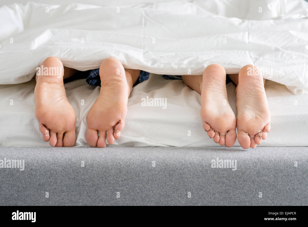 Des couples doux pieds semelles sur lit Banque D'Images