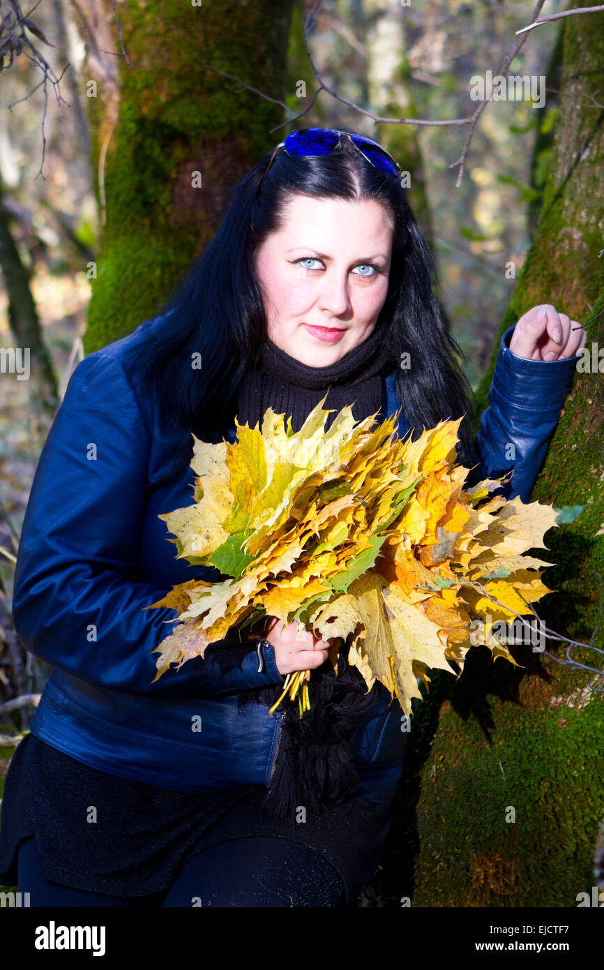 Fille jouant dans la forêt avec des feuilles Banque de photographies et  d'images à haute résolution - Alamy