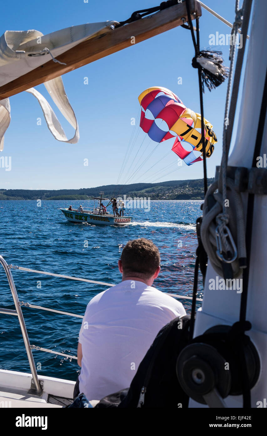 Le parapente voile de partir, vu de l'yacht de Barbarie sur le lac Taupo, Nouvelle-Zélande. Banque D'Images