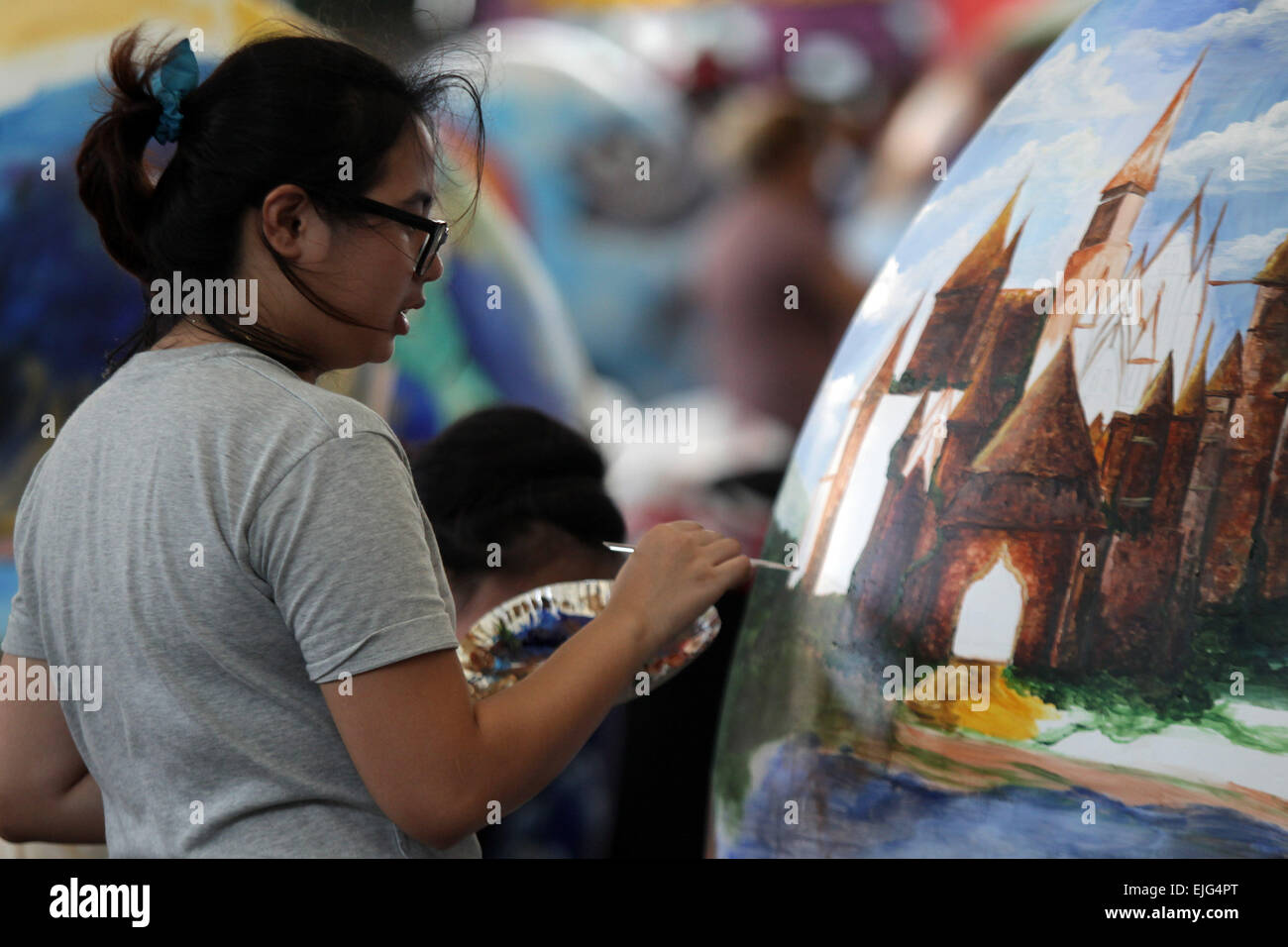 Quezon City, Philippines. 26 mars, 2015. Un artiste peint un œuf en papier  mâché géant au cours de l'Œuf de Pâques géant Concours de peinture dans la  ville de Quezon, Philippines, le