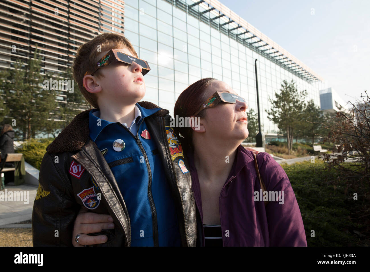 Les gens qui suivent l'éclipse partielle du soleil à l'extérieur Millennium Point à Birmingham. Banque D'Images