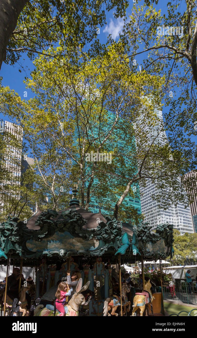 Jeune fille sur carrousel dans Bryant Park, New York City, USA Banque D'Images