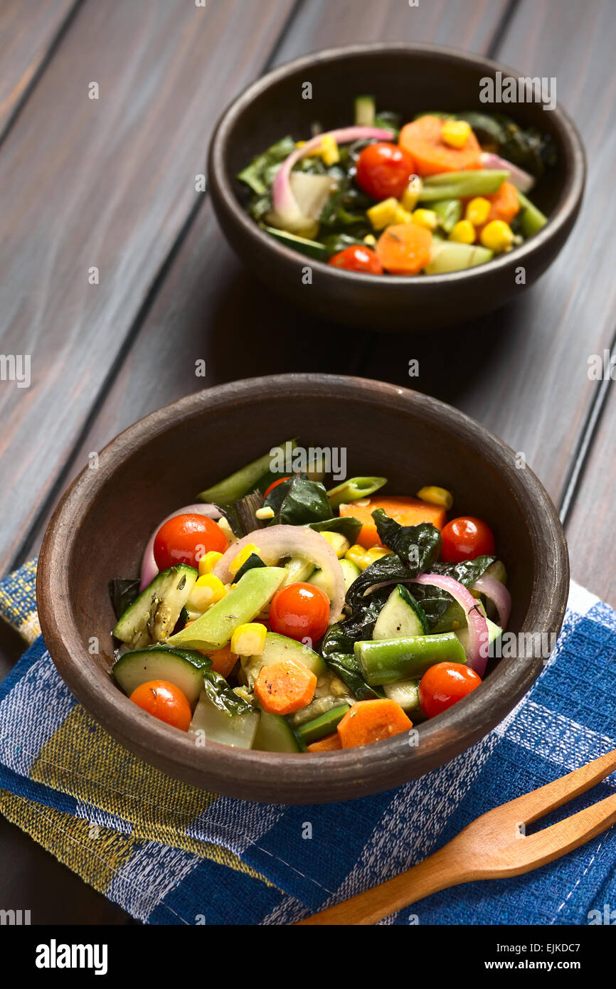 Deux bols de légumes au four rustique (courgette, oignon, tomate cerise, brocoli, carottes, maïs doux, haricot vert, blettes) Banque D'Images