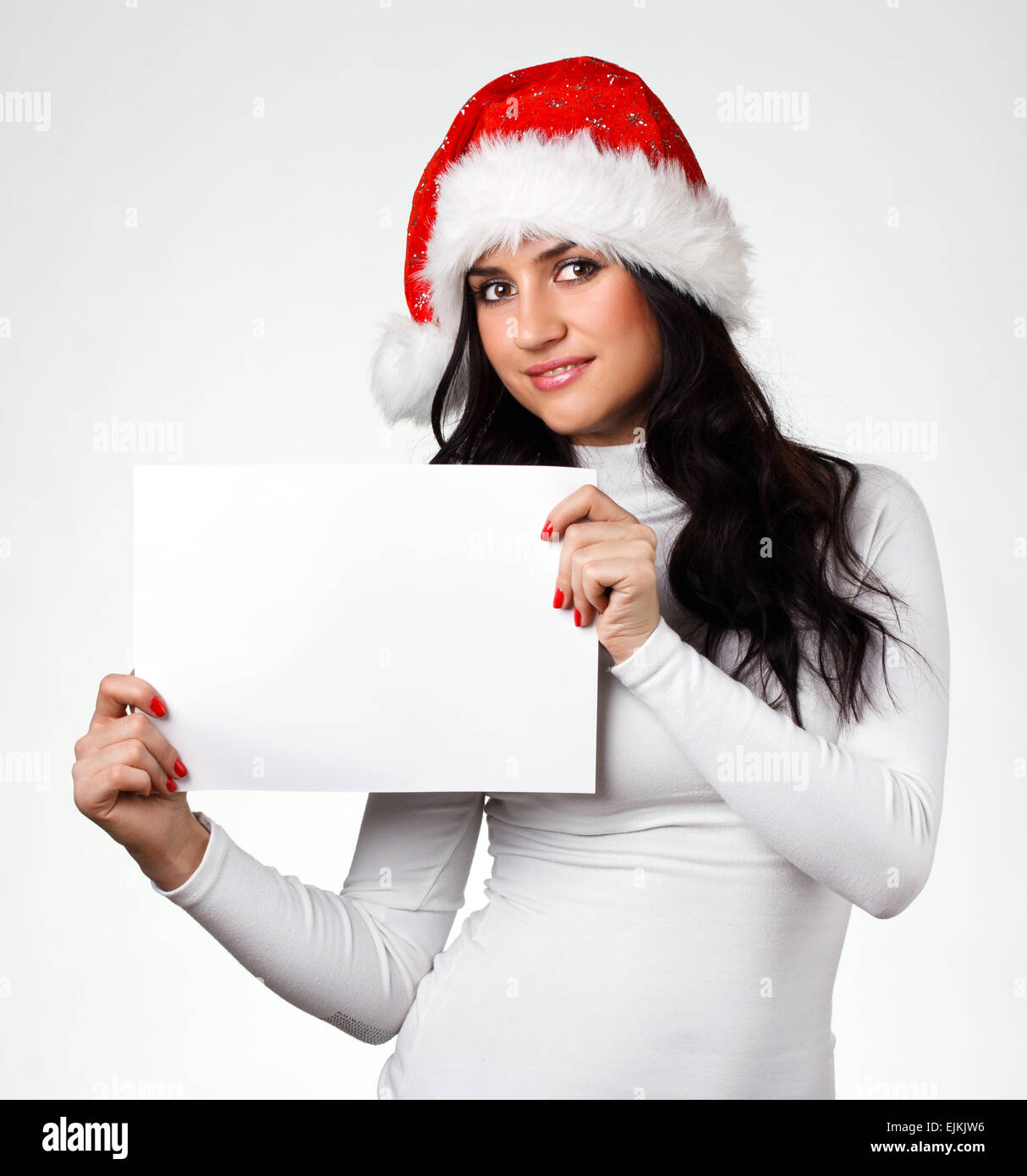 Une belle fille de Santa Claus hat avec une feuille de papier propre Banque D'Images